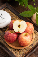 Fresh fruits and small apples on the background of retro Chinese style tea tray