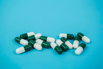 Spilled colored pills on a blue background. Pharmacology and medicine struggle for health....