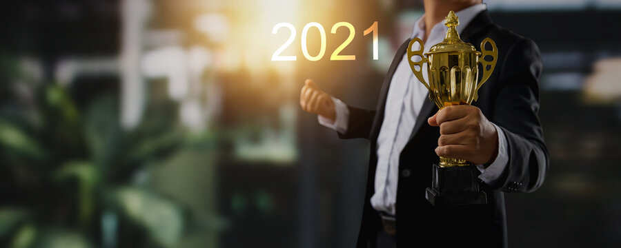 success and winner award in 2021 concept, businessman leadership, confident manager holding gold trophy