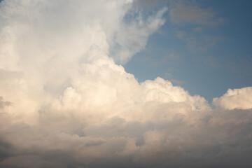 Beautiful sky background. Light blue sky with dramatic orang, pink, and gray clouds. Perfect for sky replacement. High quality photo