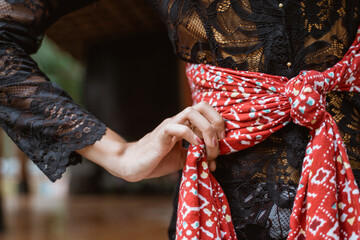 portrait young woman presenting traditional Javanese dance movements being hold shawl