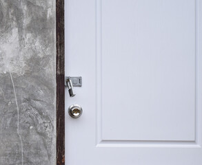 Padlock at the white door texture background with copy space.