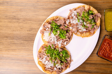 Roast tacos with corn tortillas. Mexican food. Mexican food concept on wooden table. Traditional Mexican food. Mexican tacos.