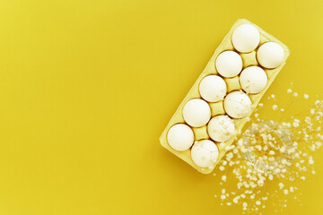 eggs pack flat lay yellow background, easter still life
