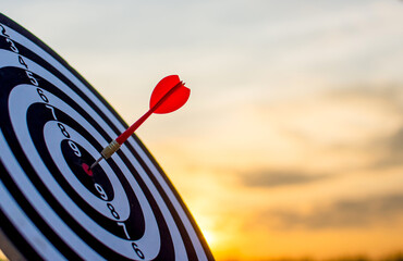 Darts sheets and golden-orange sky, targeting concept for achieving goals.