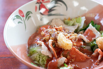 Yen Ta Four, Authentic Thai-style noodle soup with fish balls, crispy wonton skin, and special homemade red sauce. Thai Style Noodle with assorted tofu and fish ball in Red Soup.