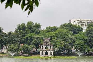 Fototapeta na wymiar Hanoi Vietnam August 18th 2018 : The Turtle tower situated on an island in Hoan Kiem Lake in Hanoi, Vietnam