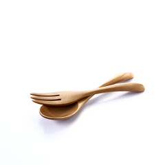 Close up wooden fork and spoon on white