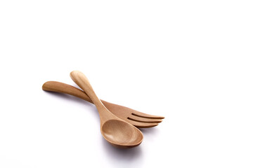 Close up wooden fork and spoon on white