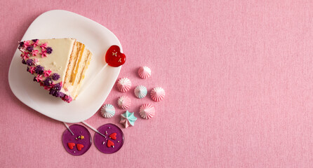 piece of cake on a plate on pink background, heart shaped lollipops, copy space, banner