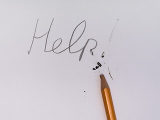 On a white sheet of paper, an inscription in pencil, a request for help. The pencil is broken,...