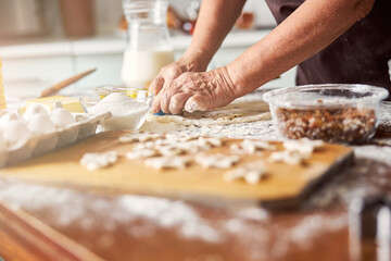 Experienced cook shaping up dough for cookies