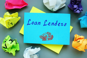 Loan Lenders sign on the piece of paper.