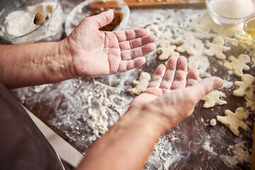 Hands of experienced baker being covered in flour