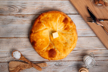 Top view on georgian cuisine megrelian khachapuri bread on the wooden table
