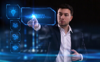 Business, Technology, Internet and network concept. Young businessman working on a virtual screen of the future and sees the inscription: Business transformation