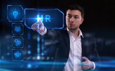 Business, Technology, Internet and network concept. Young businessman working on a virtual screen of the future and sees the inscription: HR