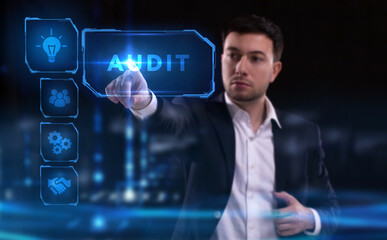 Business, Technology, Internet and network concept. Young businessman working on a virtual screen of the future and sees the inscription: Audit