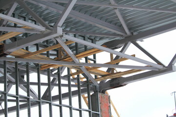Fototapeta premium An old steel metal farm. structure of metal structure of frame-type industrial building. Lightweight metal frame construction.