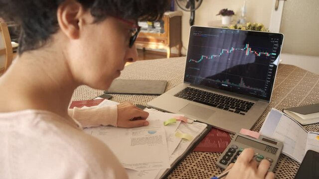 Home office working environment. Using laptop and working efficiently. Using technology and working at home productively. Young female adult study focused.