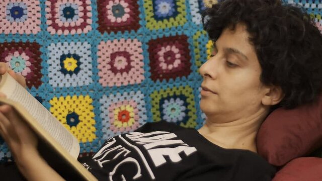 Reading book. Young female read a book and turn page. Leisure time at home.