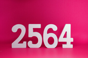 2564 number wooden object on Pink background and copy space - Happy new year 2564 , Chinese new year - Pink concept - Thai Year