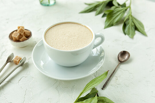 lovely fragrant latte in a white cup on a white background