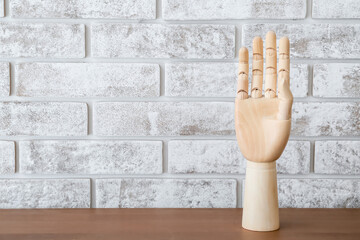 Wooden hand standing on table