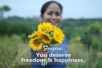 Inspirational quote - Forgive. You deserve freedom and happiness. With young woman hand holding and...