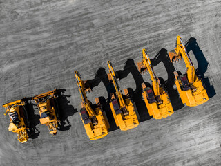 Sale of specialized equipment for mining coal, iron ore and gold. Yellow excavators and bulldozers...