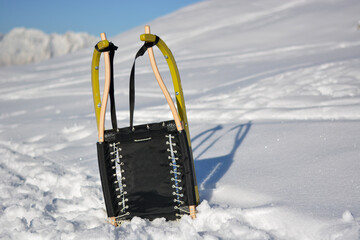 a yellow sled on the snow