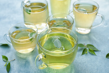 Cups of tasty green tea on table