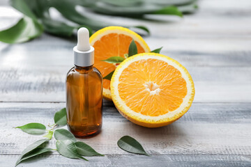 Bottle of orange essential oil on table