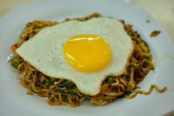 Malaysian styled fried noodles with egg on top