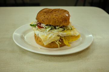 Malaysian styled chicken burger with egg on the plate