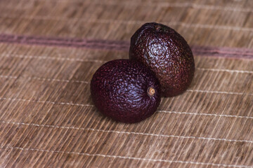 Two dark purple avocados ready to eat