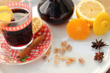 fresh mulled wine in a glass with orange and lemon
