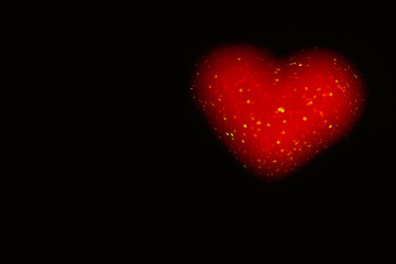 On black isolated background red defocused heart from bokeh. Greeting card. Texture for website, banner, poster. Preparation the layout for Valentine's Day, Mother's Day, March 8. Copy space. Template