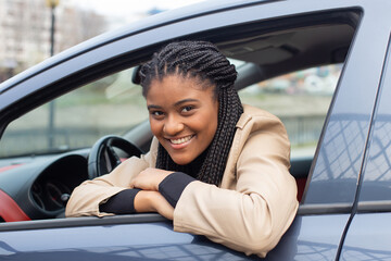 Happy girl in a car driving, African American