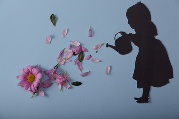 silhouette of a little girl with flowers on a blue background