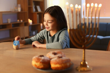 Happy little girl celebrating Hannukah at home