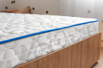 Modern orthopedic mattress on bed in room