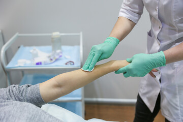 waxing procedure in the beautician's office. woman's hand epilation with wax strip
