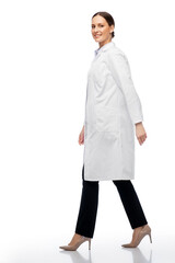 medicine, profession and healthcare concept - happy smiling female doctor or scientist in white coat walking