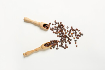 Scoops with coffee beans on white background