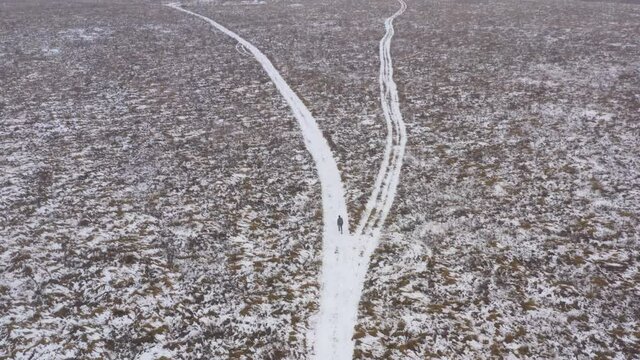 A man walking on a snowy road