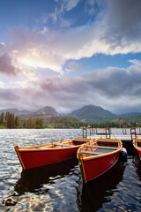Fototapeta na wymiar Red boats on a lake lake Strbske pleso.