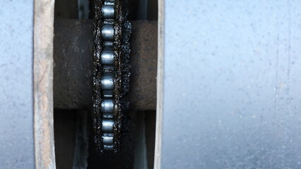 Chain and cog on the shaft. Chain force transmission mechanism on the road roller wheel axle with copy area. Select the content and close the focus