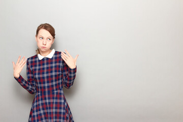 Portrait of tired girl raising and waving hands, puffing cheeks