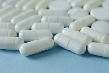 White pills on blue background